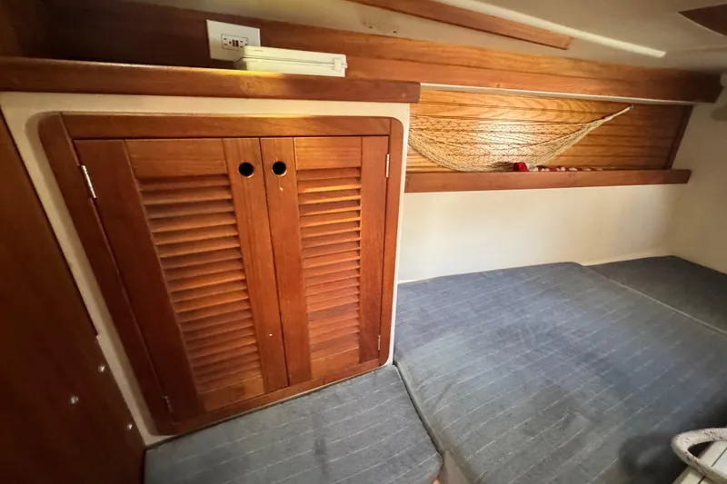 Slide: The Image of Interior cabin of a 1990 Catalina 42 MkII sailboat with wooden storage and bedding. - 26