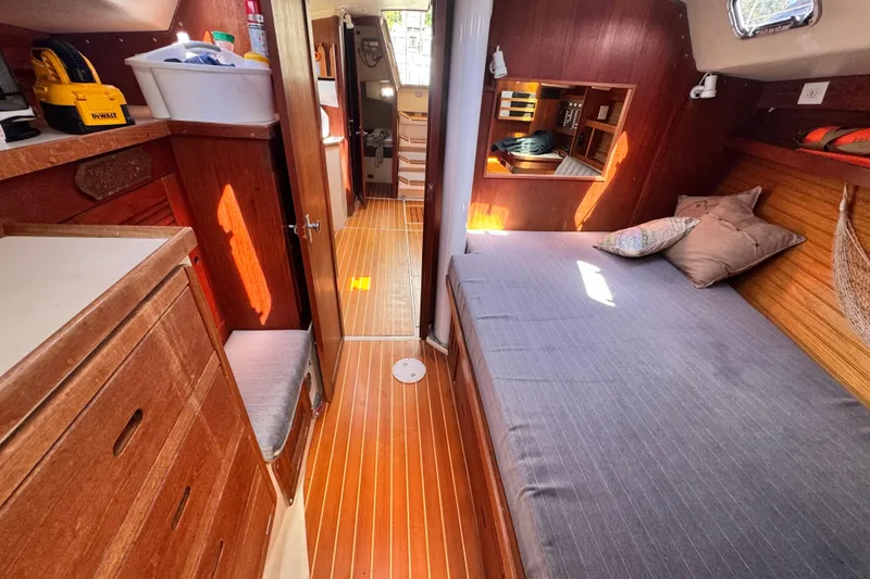 Slide: The Image of Cozy interior of 1990 Catalina 42 MkII sailboat with wooden furnishings and comfortable bedding. - 28