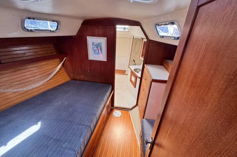 Slide: The Image of Cozy cabin interior of a 1990 Catalina 42 MkII sailboat with wood finishes and a bed. - 29