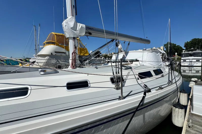 Slide: The Image of Catalina 42 MkII 1990 sailboat docked at marina under clear blue sky. - 3