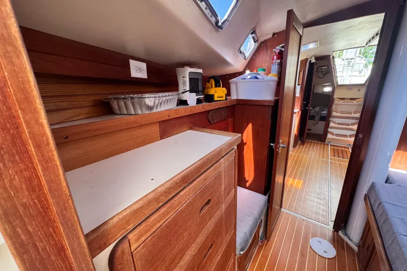 Slide: The Image of Interior of a 1990 Catalina 42 MkII sailboat with wooden cabinetry and flooring. - 31