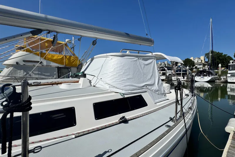 Slide: The Image of 1990 Catalina 42 MkII sailboat docked in a marina under clear blue skies. - 4