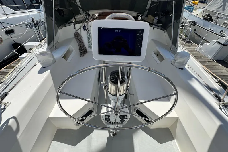 Slide: The Image of Cockpit of a 1990 Catalina 42 MkII sailboat with steering wheel and navigation equipment. - 6