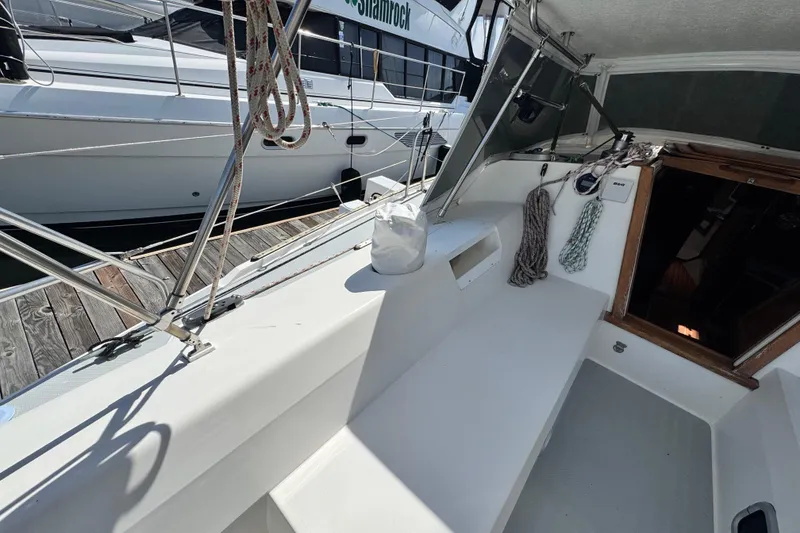 Slide: The Image of Cockpit of a 1990 Catalina 42 MkII sailboat docked at a marina. - 8