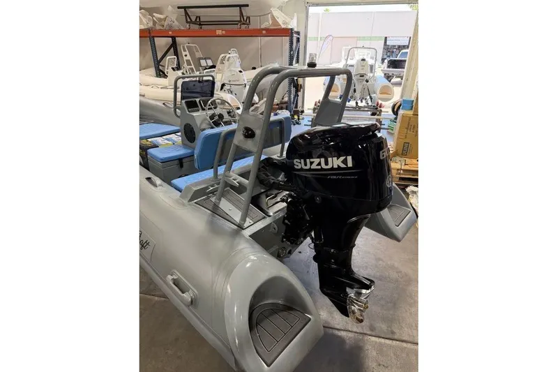 Slide: The Image of 2026 Tide Craft Custom Grey and Blue Catalina 13 boat with Suzuki outboard motor. - 2