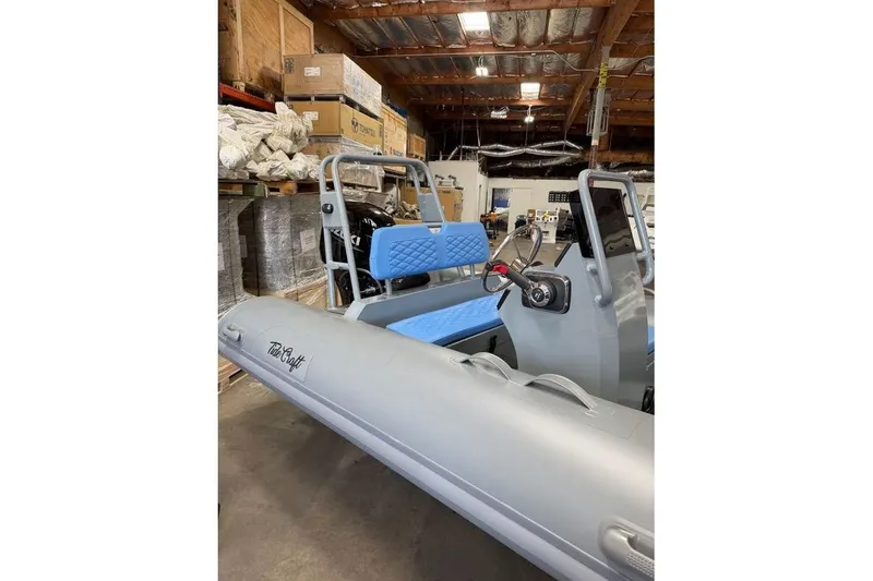Slide: The Image of 2026 Tide Craft Custom Grey and Blue Catalina 13 boat in a warehouse setting. - 4