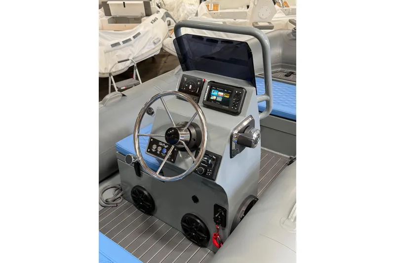 Slide: The Image of 2026 Tide Craft Custom Grey and Blue Catalina 13 boat console with steering wheel and controls. - 5