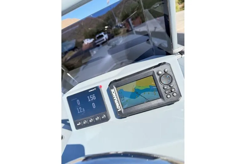 Slide: The Image of Dashboard of 2027 Tide Craft Custom Grey and Blue Catalina 13 with navigation equipment. - 6