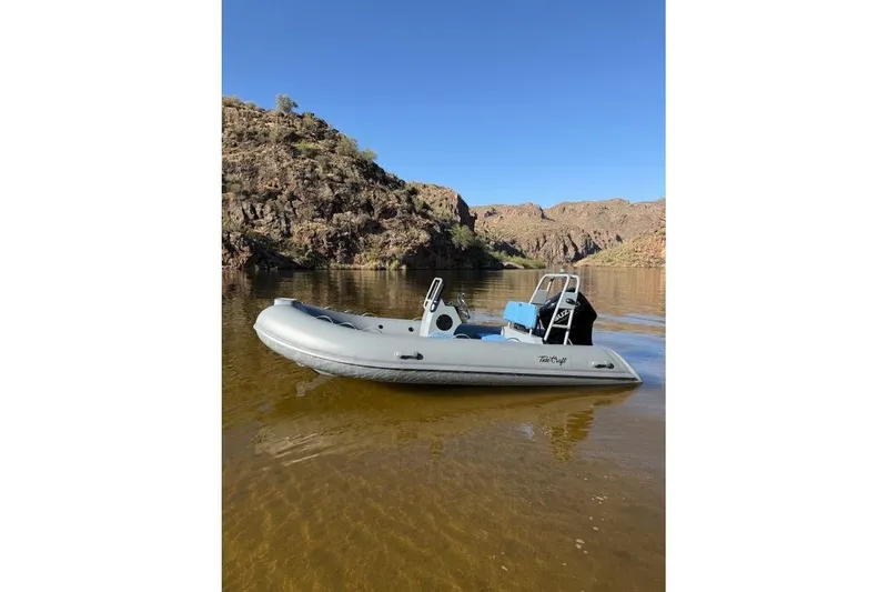 Slide: The Image of 2027 Tide Craft Custom Grey and Blue Catalina 13 boat on a serene lake. - 7