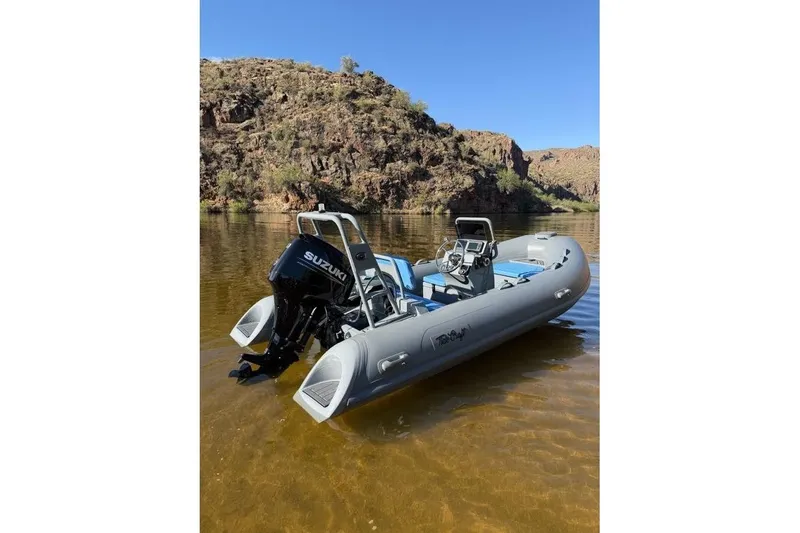 Slide: The Image of Tide Craft Custom Grey and Blue Catalina 13 boat on a serene lake, 2027 model. - 9