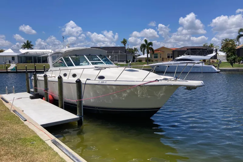 The Image of 1995 Tiara Yachts 4000 Express docked in a sunny marina setting. - 0