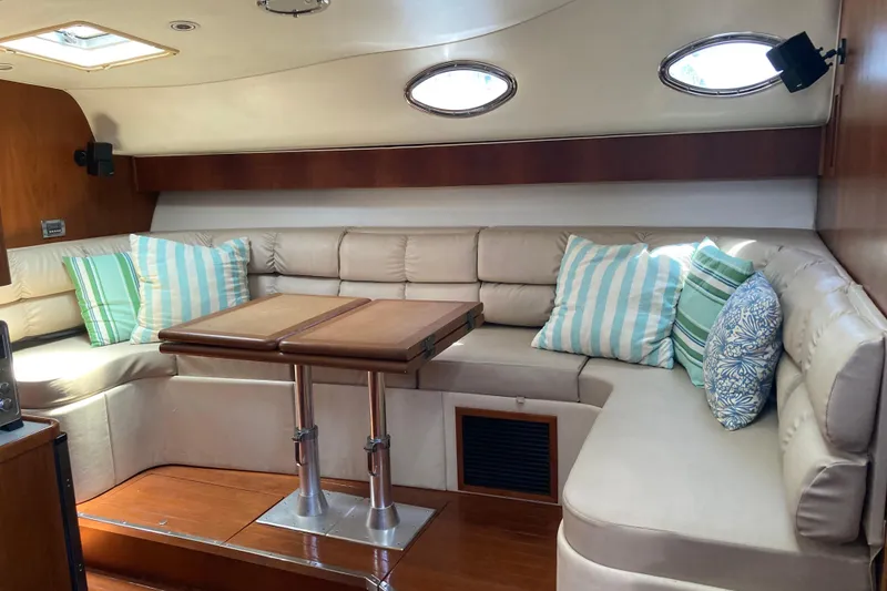 Slide: The Image of Luxurious interior of 1995 Tiara Yachts 4000 Express with plush seating and striped cushions. - 11