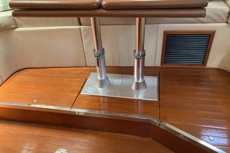 Slide: The Image of Interior of 1995 Tiara Yachts 4000 Express with polished wood flooring and metal table supports. - 12