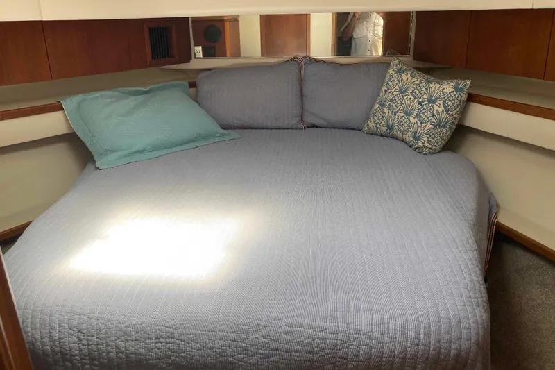 Slide: The Image of Cozy cabin interior of 1995 Tiara Yachts 4000 Express with comfortable bedding. - 16
