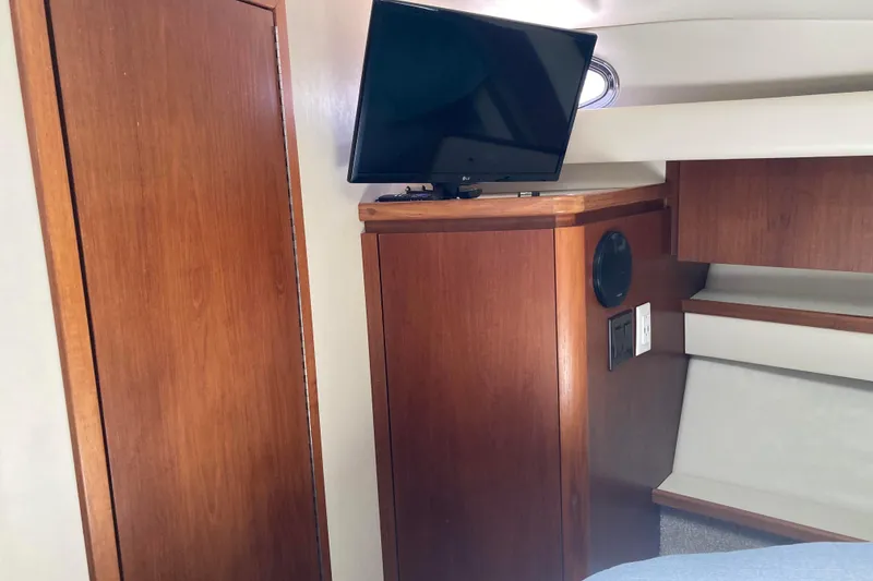 Slide: The Image of 1995 Tiara Yachts 4000 Express cabin interior with TV and wooden cabinetry. - 17