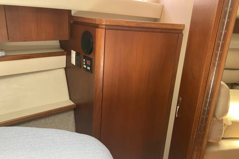 Slide: The Image of Interior of 1995 Tiara Yachts 4000 Express, featuring wooden cabinetry and control panel. - 18