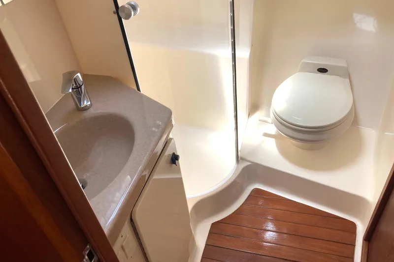 Slide: The Image of Bathroom interior of 1995 Tiara Yachts 4000 Express with sink and toilet. - 19