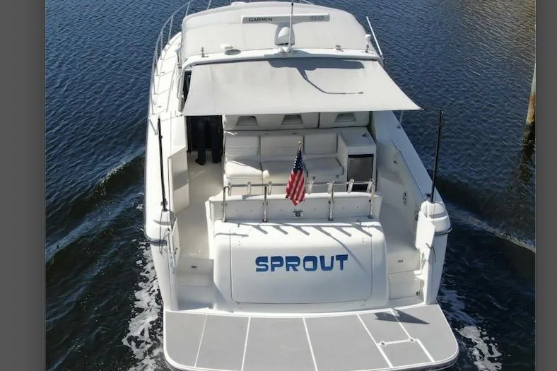 Slide: The Image of 1995 Tiara Yachts 4000 Express boat named "Sprout" on water, rear view. - 2