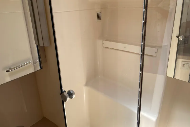 Slide: The Image of Bathroom interior of 1995 Tiara Yachts 4000 Express with glass shower door. - 20