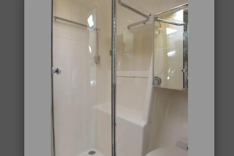 Slide: The Image of Shower area in 1995 Tiara Yachts 4000 Express, featuring glass door and modern fixtures. - 21
