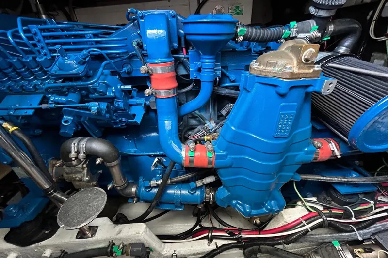Slide: The Image of Engine compartment of a 1995 Tiara Yachts 4000 Express, showcasing blue machinery and components. - 24