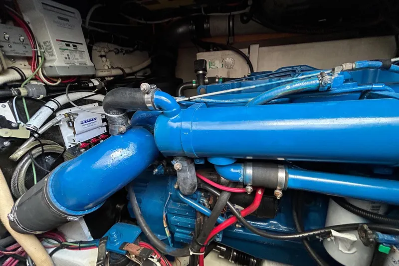 Slide: The Image of Engine compartment of a 1995 Tiara Yachts 4000 Express, featuring blue engine components. - 25