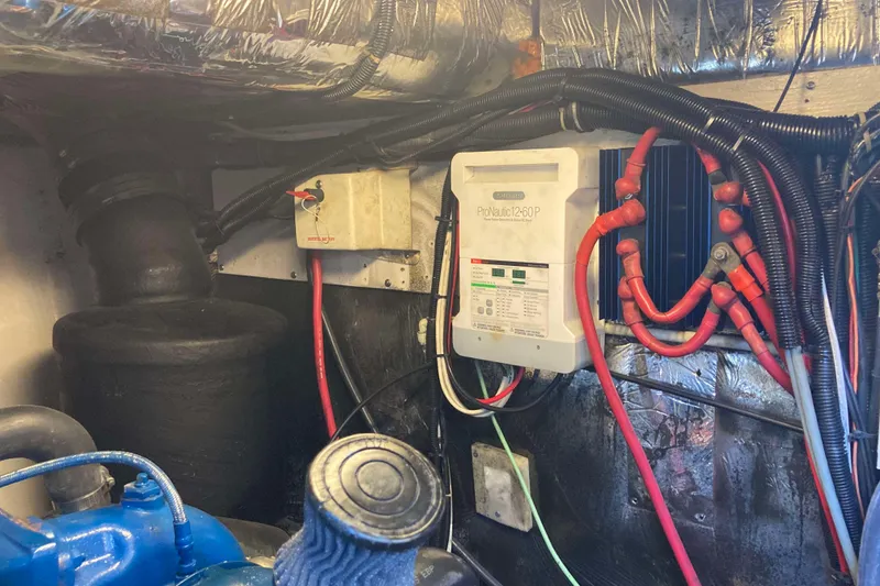 Slide: The Image of Engine room of a 1995 Tiara Yachts 4000 Express with electrical components and wiring. - 30