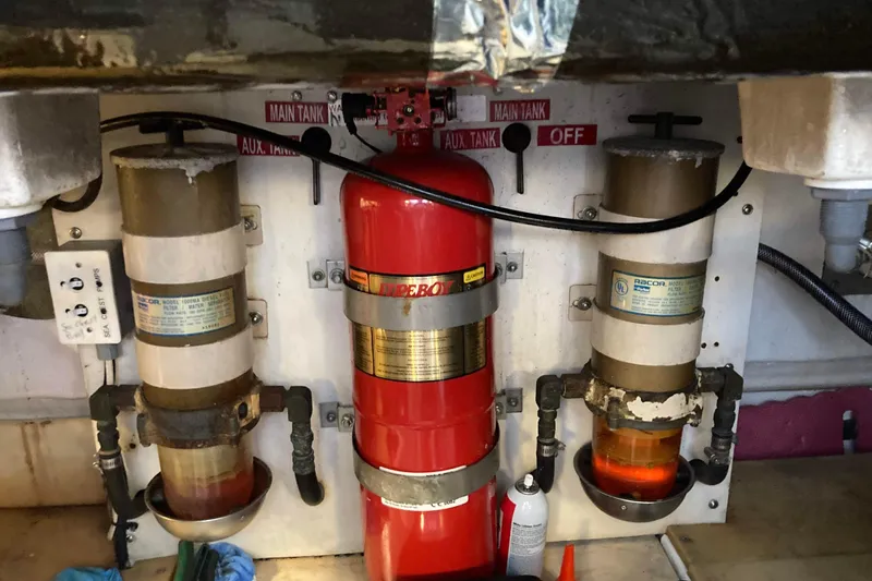 Slide: The Image of Engine room of 1995 Tiara Yachts 4000 Express with fire extinguisher and fuel filters. - 33