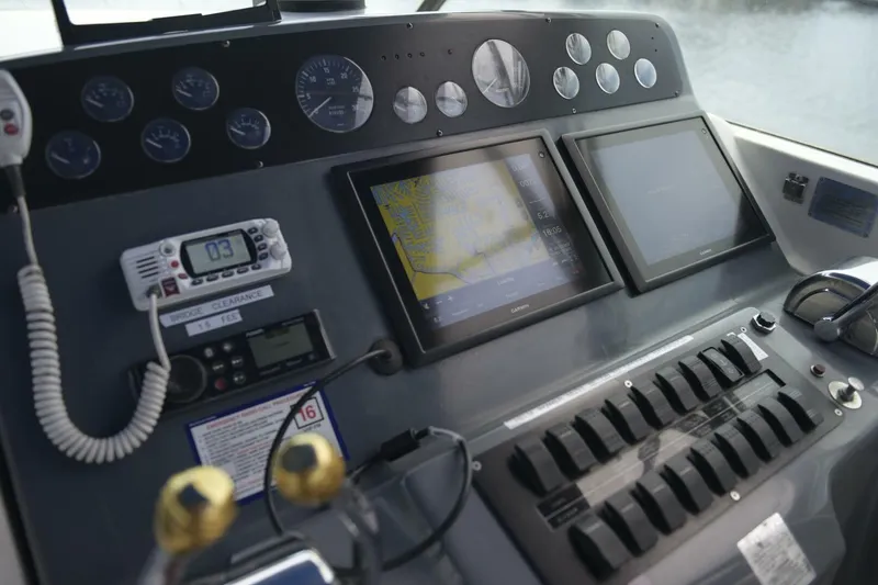 Slide: The Image of Control panel of a 1995 Tiara Yachts 4000 Express with navigation screens and gauges. - 5