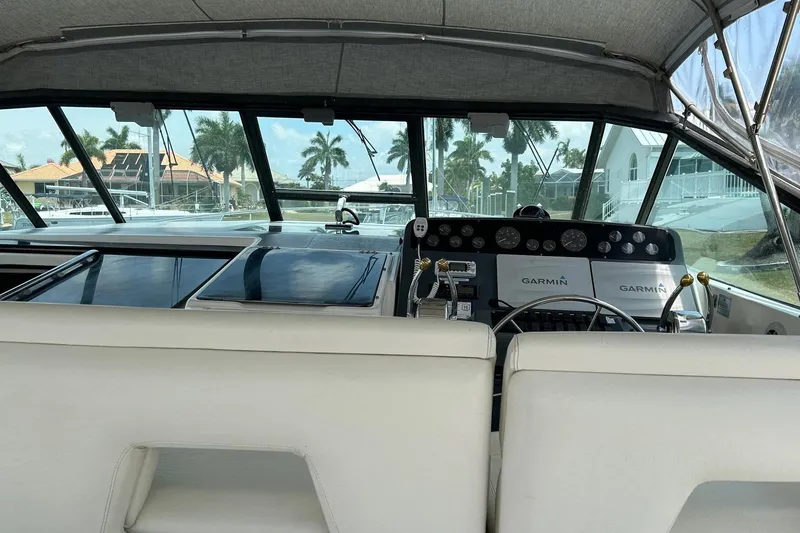 Slide: The Image of 1995 Tiara Yachts 4000 Express cockpit with Garmin navigation, featuring luxurious seating and controls. - 7