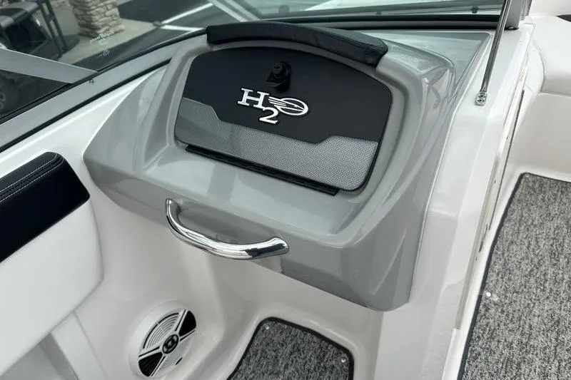 Slide: The Image of 2018 Chaparral 19 H2O Sport boat dashboard with H2O logo and speaker. - 13