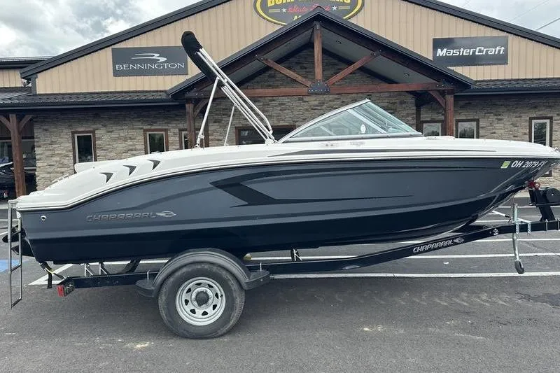 Slide: The Image of 2018 Chaparral 19 H2O Sport boat on trailer, parked outside dealership. - 14