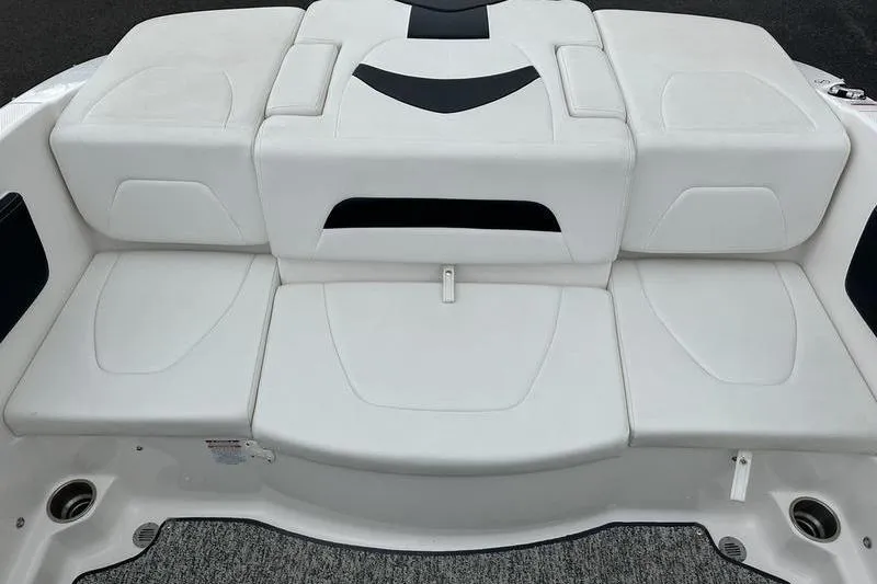 Slide: The Image of 2018 Chaparral 19 H2O Sport boat seating area, featuring white cushioned seats. - 21