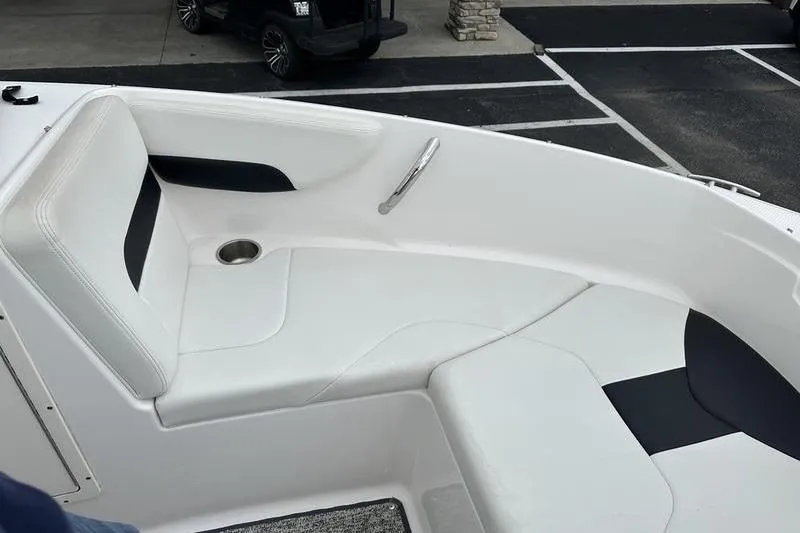 Slide: The Image of 2018 Chaparral 19 H2O Sport boat interior with white seating and cup holder. - 23