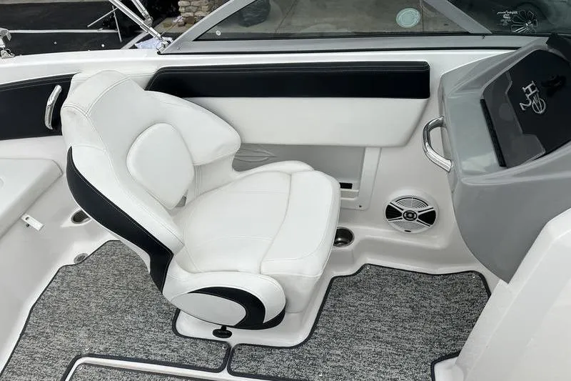 Slide: The Image of 2018 Chaparral 19 H2O Sport boat interior with white captain's chair and dashboard. - 5