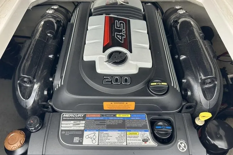 Slide: The Image of Engine of a 2018 Chaparral 19 H2O Sport boat, featuring a Mercury 4.5L 200 HP. - 7