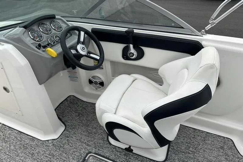 Slide: The Image of 2018 Chaparral 19 H2O Sport boat cockpit with steering wheel and white captain's chair. - 8