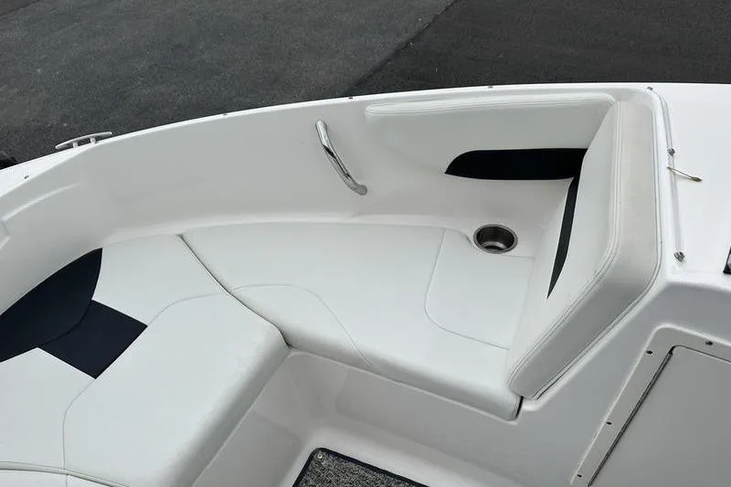 Slide: The Image of 2018 Chaparral 19 H2O Sport boat interior with white seating and cup holder. - 9