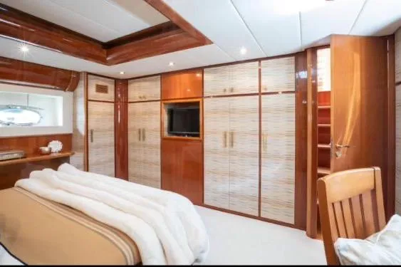 Slide: The Image of Luxurious bedroom interior of 2003 Gianetti 86 Motoryacht with wood paneling and built-in TV. - 11
