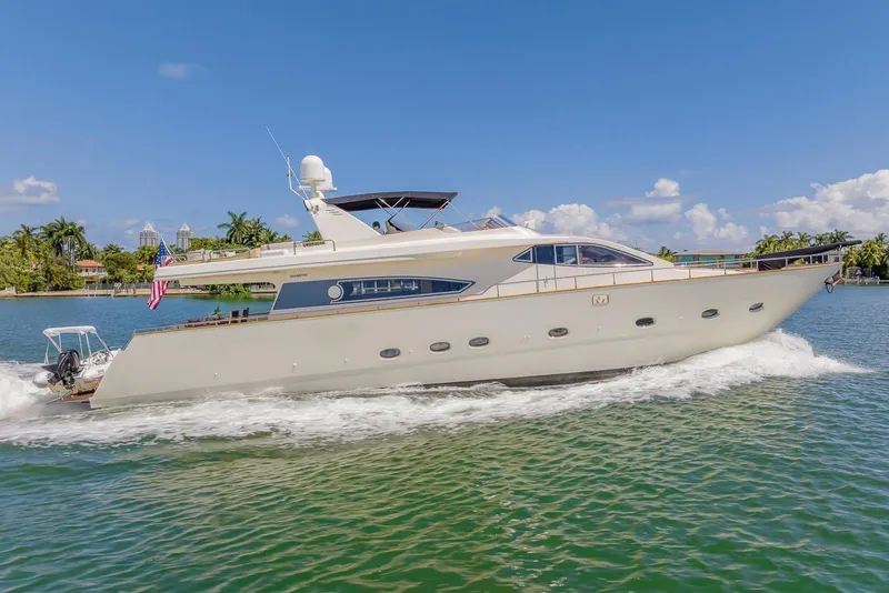 Slide: The Image of 2003 Gianetti 86 Motoryacht cruising on a sunny day, surrounded by lush greenery. - 3