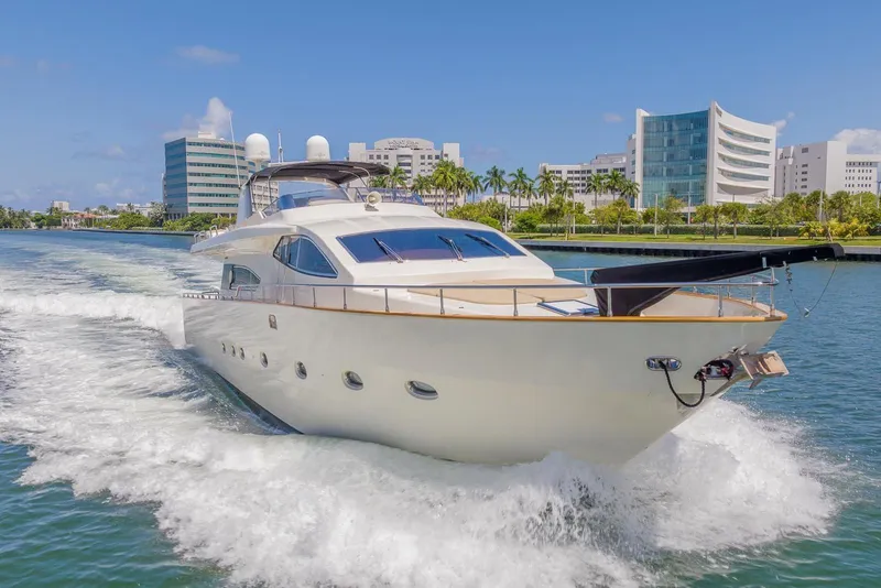 Slide: The Image of Luxurious 2003 Gianetti 86 Motoryacht cruising in a scenic urban waterway. - 5