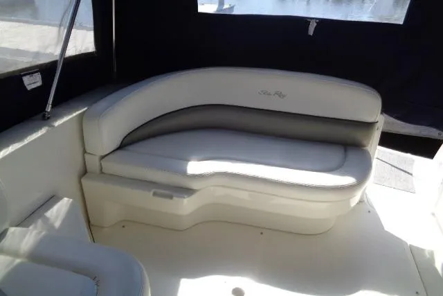 Slide: The Image of 2005 Sea Ray Sundancer 260 interior with curved seating and elegant upholstery. - 12