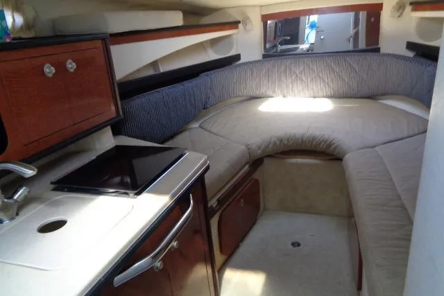 Slide: The Image of Interior of 2005 Sea Ray Sundancer 260 boat with cozy seating and kitchenette. - 16