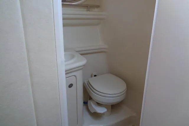 Slide: The Image of Compact bathroom in 2005 Sea Ray Sundancer 260 boat, featuring toilet and sink. - 19
