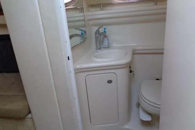 Slide: The Image of 2005 Sea Ray Sundancer 260 bathroom with sink, mirror, and toilet. - 20