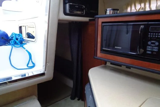Slide: The Image of Interior of 2005 Sea Ray Sundancer 260 with microwave and blue rope. - 21