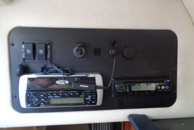 Slide: The Image of Control panel of a 2005 Sea Ray Sundancer 260 boat with audio system and switches. - 22