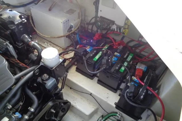 Slide: The Image of Engine compartment of a 2005 Sea Ray Sundancer 260 with visible batteries and wiring. - 28