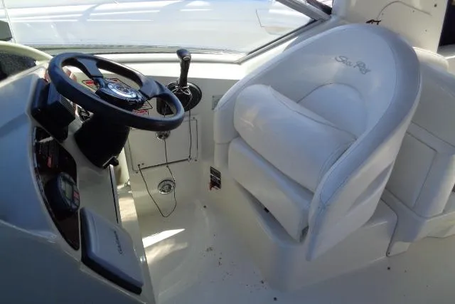 Slide: The Image of Cockpit of 2005 Sea Ray Sundancer 260 with steering wheel and white captain's chair. - 7