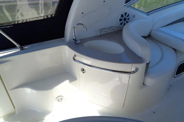 Slide: The Image of 2005 Sea Ray Sundancer 260 interior with sink and seating area. - 9